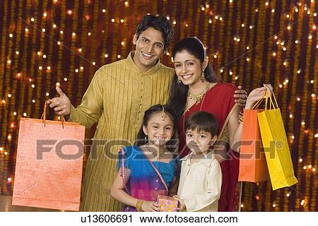 Stock Image - Portrait of a family with shopping bags. Fotosearch