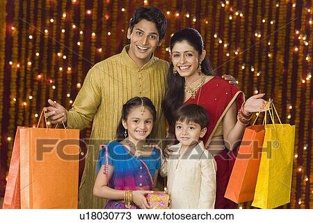 Stock Image - Portrait of a family with shopping bags. Fotosearch