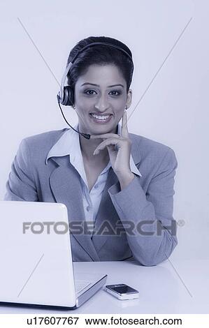 Stock Photo - Portrait of a female customer service representative. Fotosearch