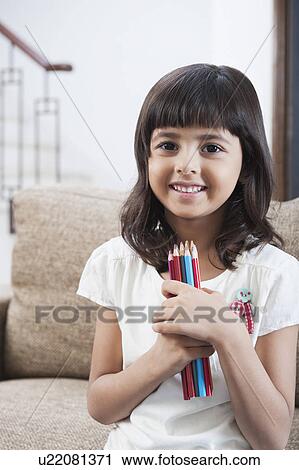 Portrait of a girl holding colored pencils View Large Photo Image Stock Image - Portrait of a girl holding colored pencils. Fotosearch