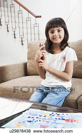 Portrait of a girl holding colored pencils View Large Photo Image Stock Photo - Portrait of a girl holding colored pencils. Fotosearch