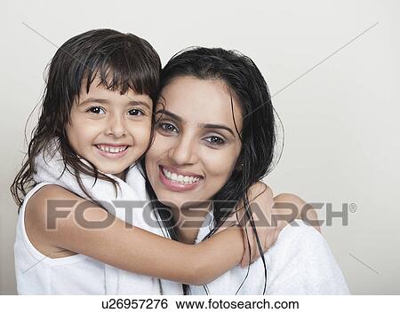 Portrait of a girl hugging her mother View Large Photo Image Stock Photograph - Portrait of a girl hugging her mother. Fotosearch