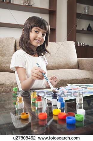 Stock Image - Portrait of a girl painting. Fotosearch