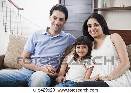 Portrait of a girl sitting with her parents View Large Photo Image Stock Image - Portrait of a girl sitting with her parents. Fotosearch