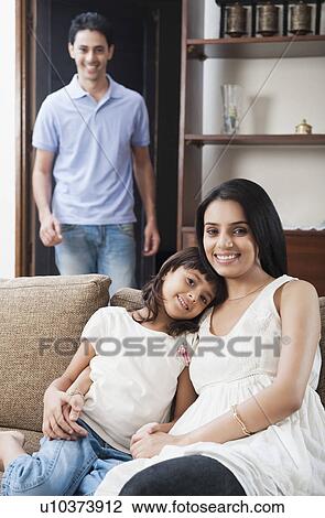 Stock Image - Portrait of a girl smiling with her mother. Fotosearch