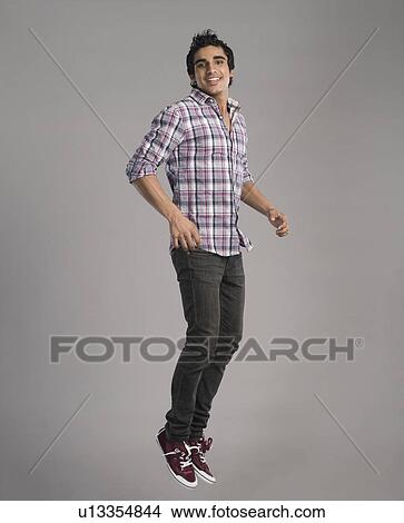 Portrait of a happy man jumping View Large Photo Image Picture - Portrait of a happy man jumping. Fotosearch