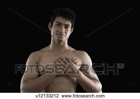 Portrait of a macho man with hands over heart View Large Photo Image Stock Image - Portrait of a macho man with hands over heart. Fotosearch