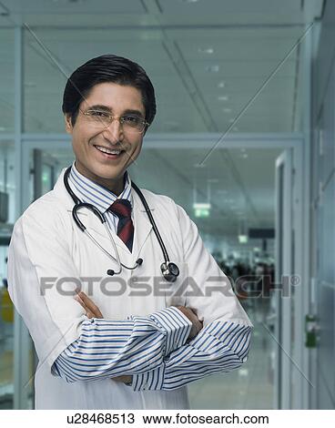 Portrait of a male doctor smiling View Large Photo Image Stock Image - Portrait of a male doctor smiling. Fotosearch