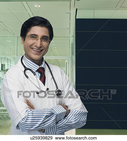 Portrait of a male doctor smiling View Large Photo Image Stock Photo - Portrait of a male doctor smiling. Fotosearch