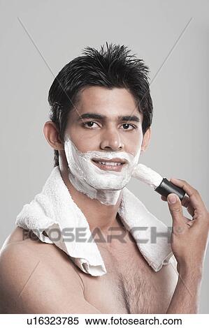 Portrait of a man applying shaving cream on face View Large Photo Image Stock Photography - Portrait of a man applying shaving cream on face. Fotosearch