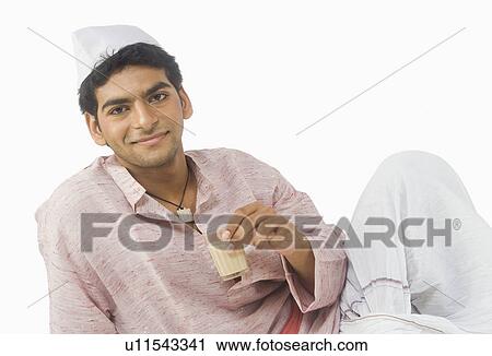 Stock Image - Portrait of a man drinking tea. Fotosearch