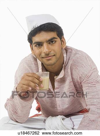 Stock Image - Portrait of a man drinking tea. Fotosearch
