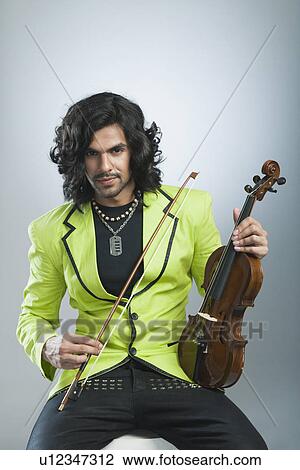 Portrait of a man holding a violin View Large Photo Image Stock Image - Portrait of a man holding a violin. Fotosearch