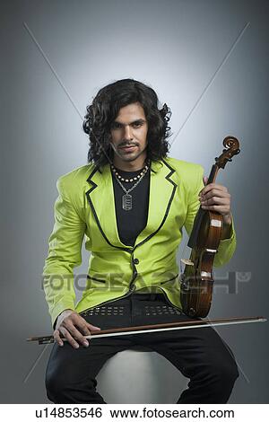 Portrait of a man holding a violin View Large Photo Image Stock Photograph - Portrait of a man holding a violin. Fotosearch