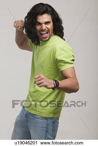 Stock Image - Portrait of a man in fighting stance. Fotosearch