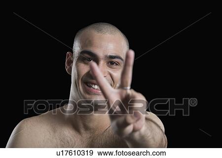 Portrait of a man making a peace sign View Large Photo Image Stock Photo - Portrait of a man making a peace sign. Fotosearch
