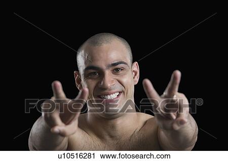 Portrait of a man making peace signs View Large Photo Image Stock Image - Portrait of a man making peace signs. Fotosearch