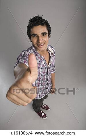 Picture - Portrait of a man showing thumbs up sign. Fotosearch