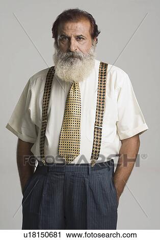 Portrait of a man standing with his hands in his pockets View Large Photo Image Stock Image - Portrait of a man standing with his hands in his pockets. Fotosearch