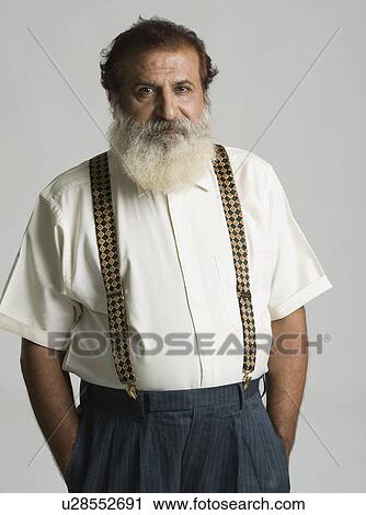Portrait of a man standing with his hands in his pockets View Large Photo Image Stock Image - Portrait of a man standing with his hands in his pockets. Fotosearch