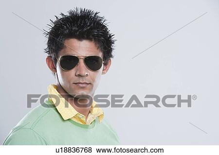 Stock Photo - Portrait of a man wearing dark glasses. Fotosearch