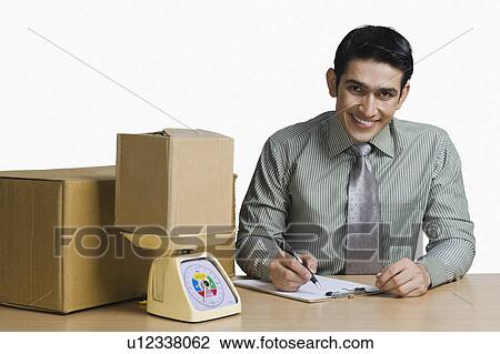 Portrait of a man weighing cardboard boxes and recording data View Large Photo Image Stock Image - Portrait of a man weighing cardboard boxes and recording data. Fotosearch