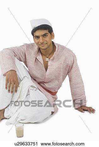 Portrait of a man with a glass of tea in front of him View Large Photo Image Stock Image - Portrait of a man with a glass of tea in front of him. Fotosearch
