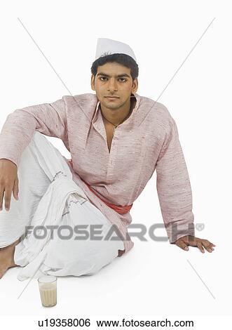 Stock Photograph - Portrait of a man with a glass of tea in front of him. Fotosearch