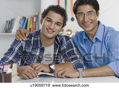 Portrait of a man with his arm around his son View Large Photo Image Stock Photo - Portrait of a man with his arm around his son. Fotosearch