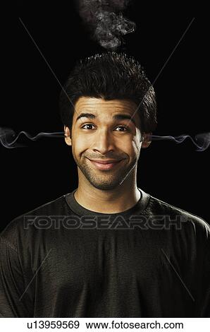 Stock Photo - Portrait of a man with smoke coming from his ears. Fotosearch