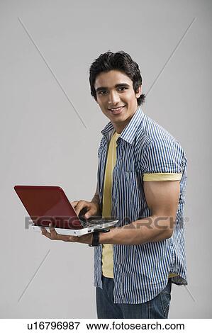 Stock Photo - Portrait of a man working on a laptop. Fotosearch