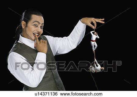 Portrait of a mime holding a rope with two acrobats performing on it View Large Photo Image Stock Photograph - Portrait of a mime holding a rope with two acrobats performing on it. Fotosearch