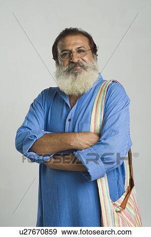 Portrait of a philosopher standing with his arms crossed View Large Photo Image Stock Photo - Portrait of a philosopher standing with his arms crossed. Fotosearch
