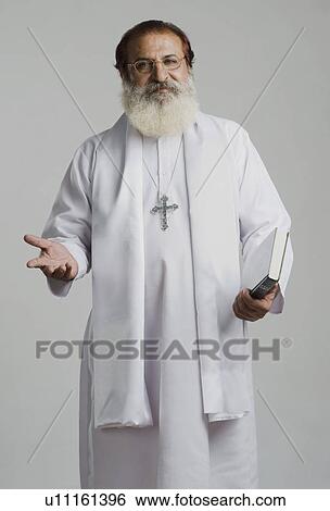 Portrait of a priest gesturing View Large Photo Image Stock Photograph - Portrait of a priest gesturing. Fotosearch