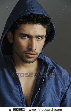 Portrait of a stylish young man wearing hooded shirt View Large Photo Image Stock Image - Portrait of a stylish young man wearing hooded shirt. Fotosearch