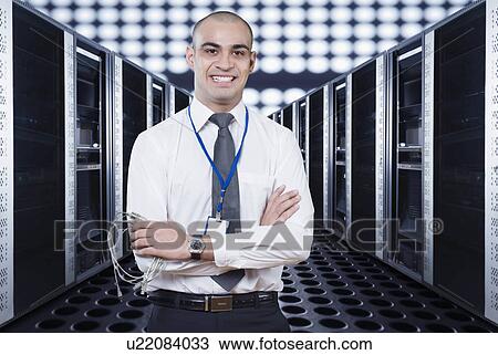 Portrait of a technician smiling in a server room View Large Photo Image Stock Image - Portrait of a technician smiling in a server room. Fotosearch