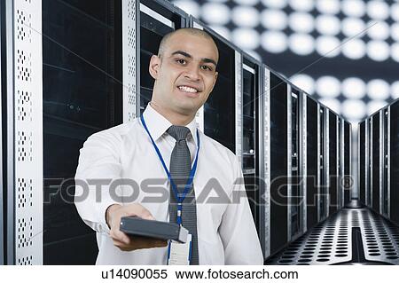 Portrait of a technician smiling in a server room View Large Photo Image Stock Photography - Portrait of a technician smiling in a server room. Fotosearch
