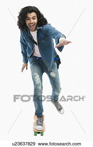 Stock Photo - Portrait of a university student skateboarding. Fotosearch