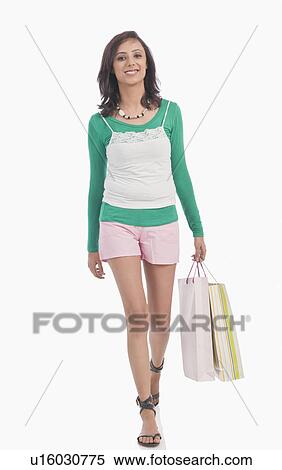 Portrait of a woman carrying shopping bags View Large Photo Image Stock Photography - Portrait of a woman carrying shopping bags. Fotosearch