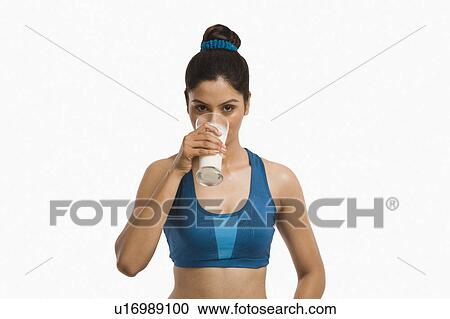 Stock Image - Portrait of a woman drinking milk. Fotosearch