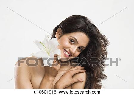 Stock Photograph - Portrait of a woman holding a Tiger Lily flower. Fotosearch