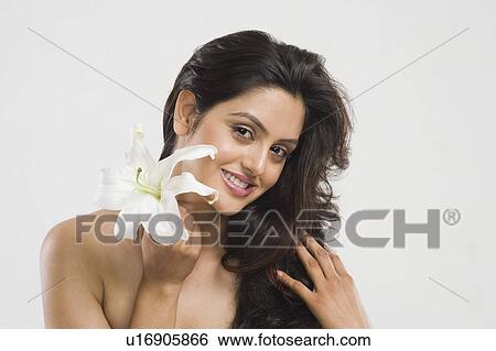 Portrait of a woman holding a Tiger Lily flower View Large Photo Image Stock Photograph - Portrait of a woman holding a Tiger Lily flower. Fotosearch