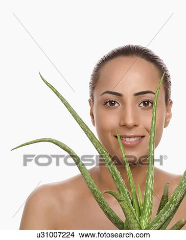 Portrait of a woman holding an Aloe Vera plant View Large Photo Image Picture - Portrait of a woman holding an Aloe Vera plant. Fotosearch
