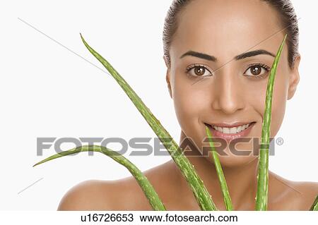Portrait of a woman holding an Aloe Vera plant View Large Photo Image Stock Image - Portrait of a woman holding an Aloe Vera plant. Fotosearch