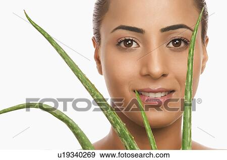 Portrait of a woman holding an Aloe Vera plant View Large Photo Image Stock Photo - Portrait of a woman holding an Aloe Vera plant. Fotosearch