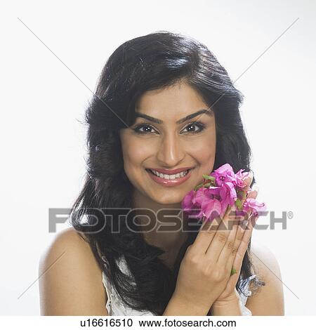 Stock Image - Portrait of a woman holding flowers. Fotosearch