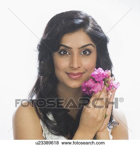 Stock Photo - Portrait of a woman holding flowers. Fotosearch