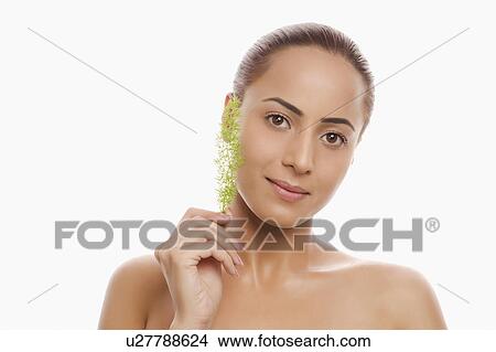 Picture - Portrait of a woman holding herb. Fotosearch