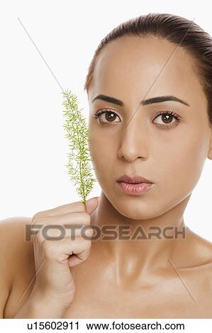 Stock Image - Portrait of a woman holding herb. Fotosearch