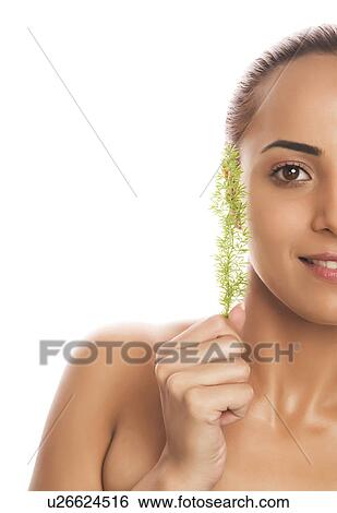 Portrait of a woman holding herb View Large Photo Image Stock Photograph - Portrait of a woman holding herb. Fotosearch